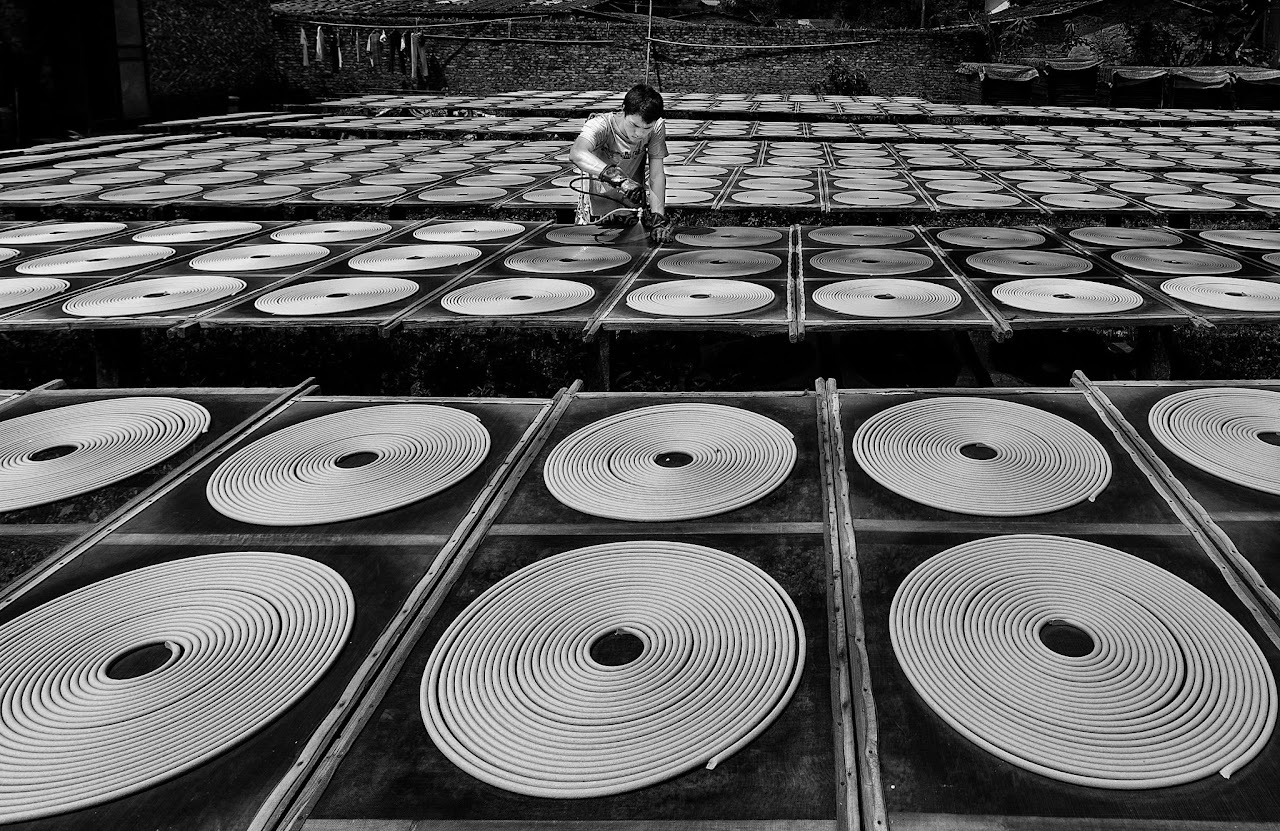 Worker surrounded by many circular coils.