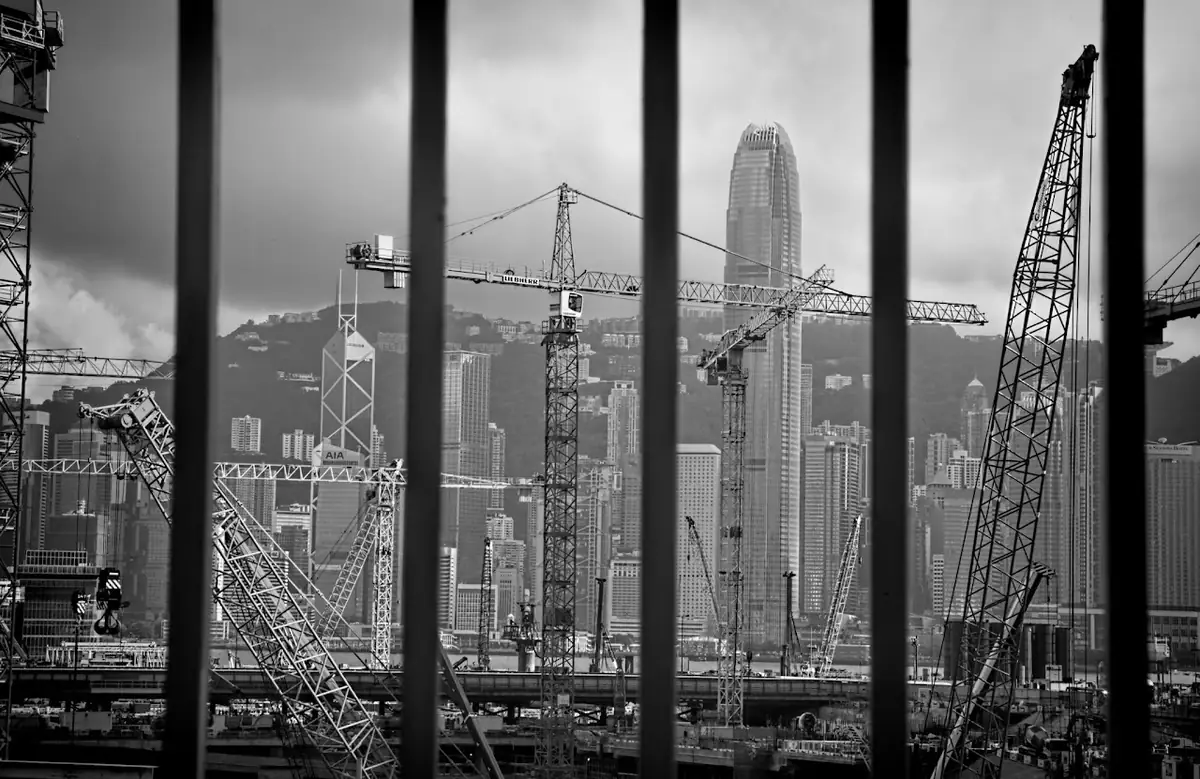 Hong Kong cranes through bars.