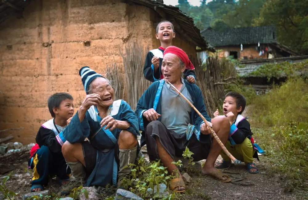 Elders and children laughing.