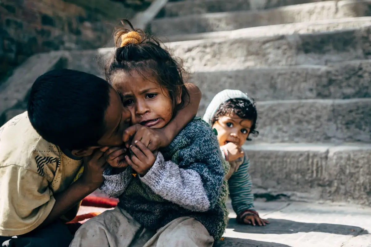 Children sitting on concrete steps.